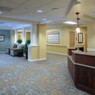 A spacious and well-lit lobby area with a reception desk and seating arrangements.