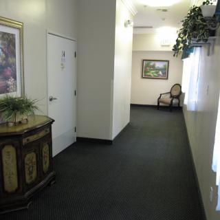 A well-decorated interior hallway with furniture and artwork.