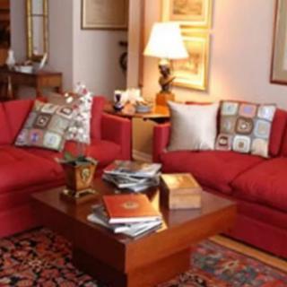 Cozy living room with red sofas and a wooden coffee table.