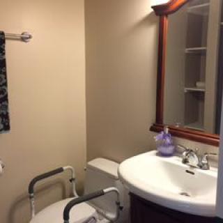 A small, well-organized bathroom with essential amenities.