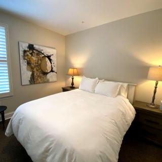 A modern bedroom with a neatly made bed and contemporary decor.