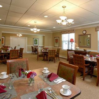 A well-decorated dining room with neatly arranged tables and chairs.