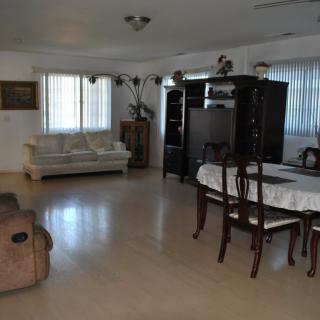 Spacious living and dining area with modern furniture.