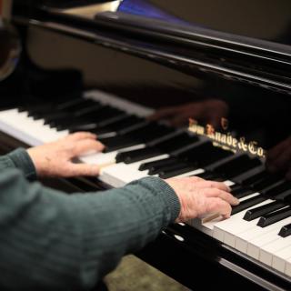 A close-up of a person playing the piano.