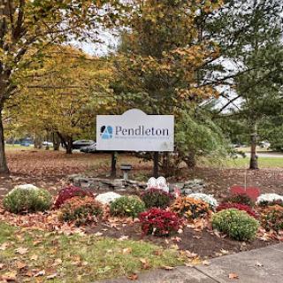 A welcoming sign amidst the colorful autumn foliage.