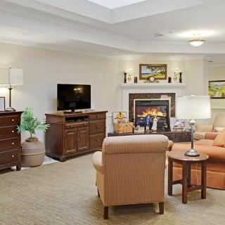 A cozy living room with a fireplace, comfortable seating, and a television.