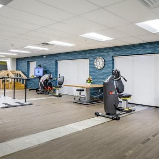A rehabilitation center featuring exercise equipment and therapy space.