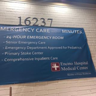 A sign outside a medical center advertising 24-hour emergency care services.