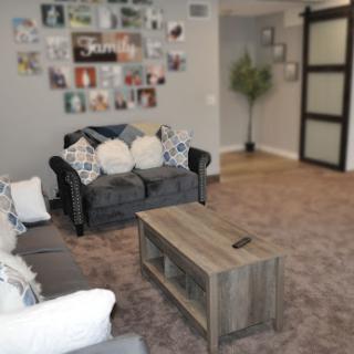 A cozy living room featuring a stylish sofa, a wooden coffee table, and decorative wall art.