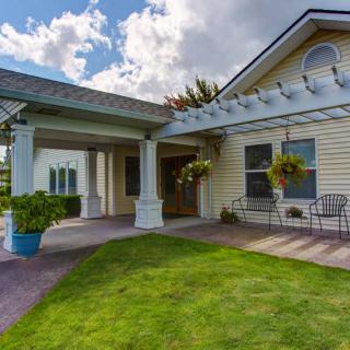 A charming house with a covered porch and well-maintained front yard.