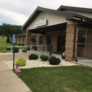 A well-maintained building with a welcoming entrance and landscaped surroundings.