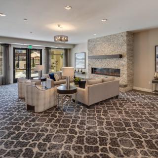 A modern living room with stylish furniture and a cozy fireplace.