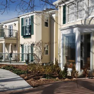 A view of a residential building with large windows and balconies on a sunny day.