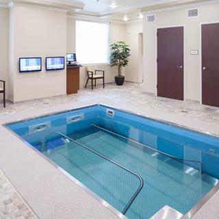 An indoor therapy pool designed for rehabilitation and exercise purposes.