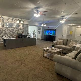 A cozy lounge area featuring comfortable sofas, a modern TV setup, and stylish decor.