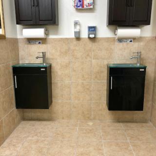 A stylish and modern bathroom setup with dual sinks and cabinets.