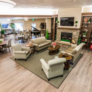 A modern living room with comfortable seating and a fireplace.