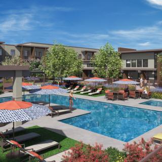 A residential complex with a swimming pool and lounge area.