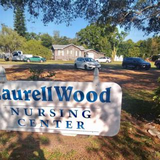 Entrance sign of Laurell Wood Nursing Center, showcasing the facility's commitment to healthcare.