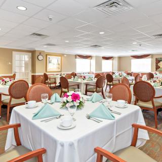 A well-arranged dining room with elegantly set tables and chairs.