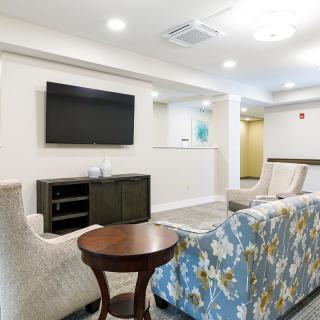 A modern living room featuring a TV, comfortable seating, and stylish decor.