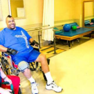 A person in a wheelchair engaging in a rehabilitation session indoors.