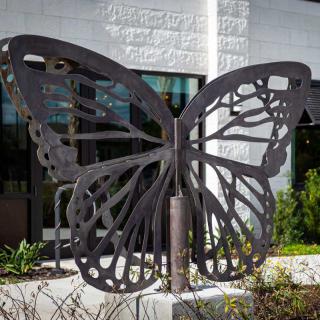 A large metal butterfly sculpture displayed outside.