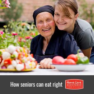 A senior enjoying a healthy meal with family in a garden.