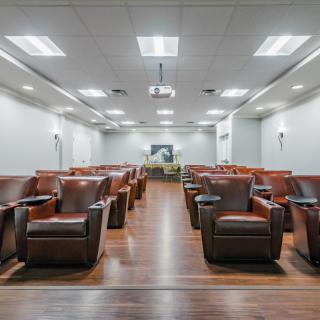 A spacious conference room with comfortable seating and modern amenities.