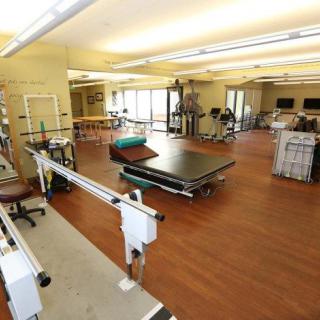 A spacious rehabilitation center equipped with physical therapy and exercise equipment.