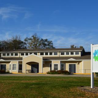 A well-maintained building showcasing modern architecture under a clear blue sky.