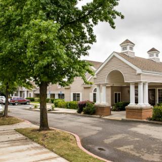 A well-designed residential building surrounded by greenery and a serene atmosphere.