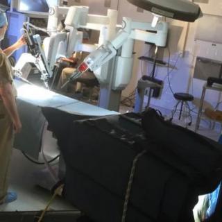 A surgical team operating with advanced robotic equipment in a modern medical facility.