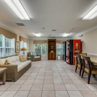 A well-lit room with comfortable seating, dining area, and vending machines.