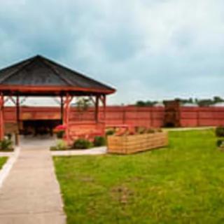 A well-maintained garden with a gazebo and pathway.