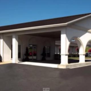 A building entrance with a covered canopy and driveway.