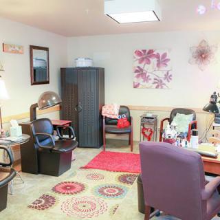 A cozy office space with chairs, a desk, and colorful decor.