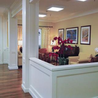 A cozy and elegantly decorated living room with comfortable seating and vibrant flowers.