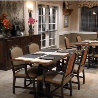 A cozy restaurant dining area with neatly arranged tables and chairs.