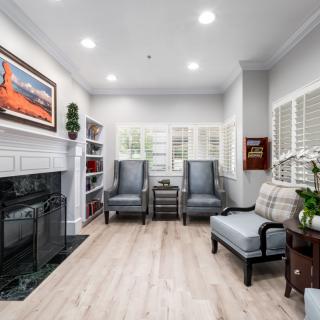 A cozy living room with a fireplace, comfortable seating, and decorative elements.