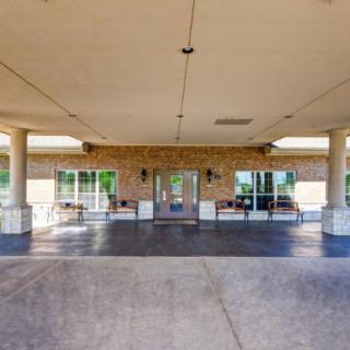 A covered entrance with columns leading to a building.