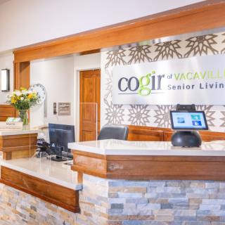 Reception desk at a senior living facility with modern decor.