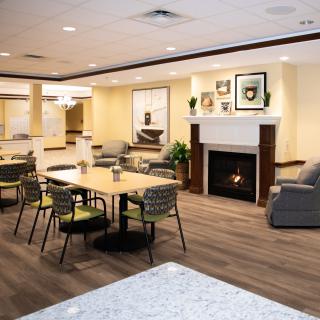 A modern living room with comfortable seating and a cozy fireplace.
