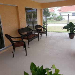 A cozy patio area with outdoor furniture and potted plants.
