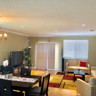 A cozy living and dining area featuring a television, comfortable seating, and stylish decor.