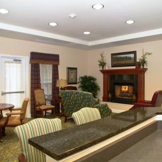 A cozy living room with a fireplace and comfortable seating.