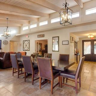 A spacious dining area with elegant lighting and modern furniture.