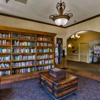 Cozy library with a large bookshelf and comfortable seating.