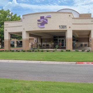 A modern healthcare facility with a welcoming entrance and landscaped surroundings.