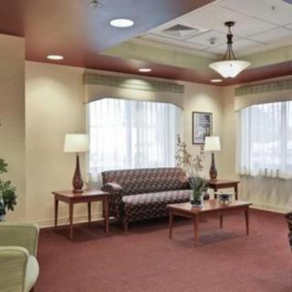 A well-furnished waiting room with comfortable seating and ambient lighting.